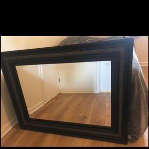 A large black frame mirror
